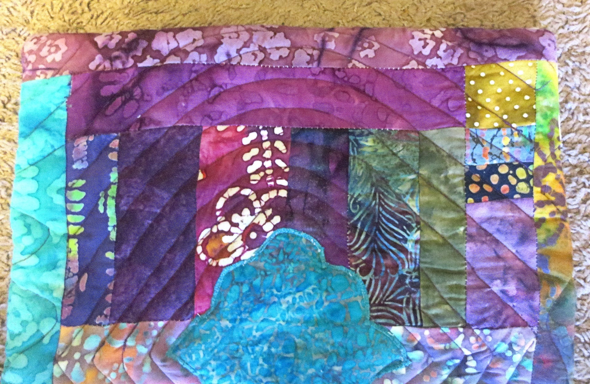 turquoise hamsa ripples in all batik trapunto wall hanging