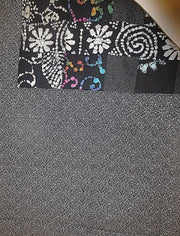 black batik and calico quilted insulated table runner with a splash of color