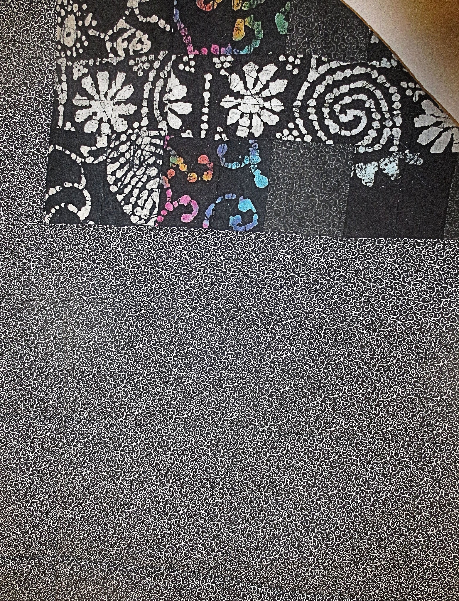 black batik and calico quilted insulated table runner with a splash of color