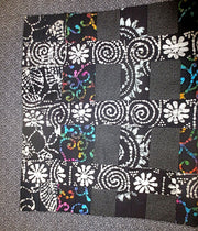 black batik and calico quilted insulated table runner with a splash of color