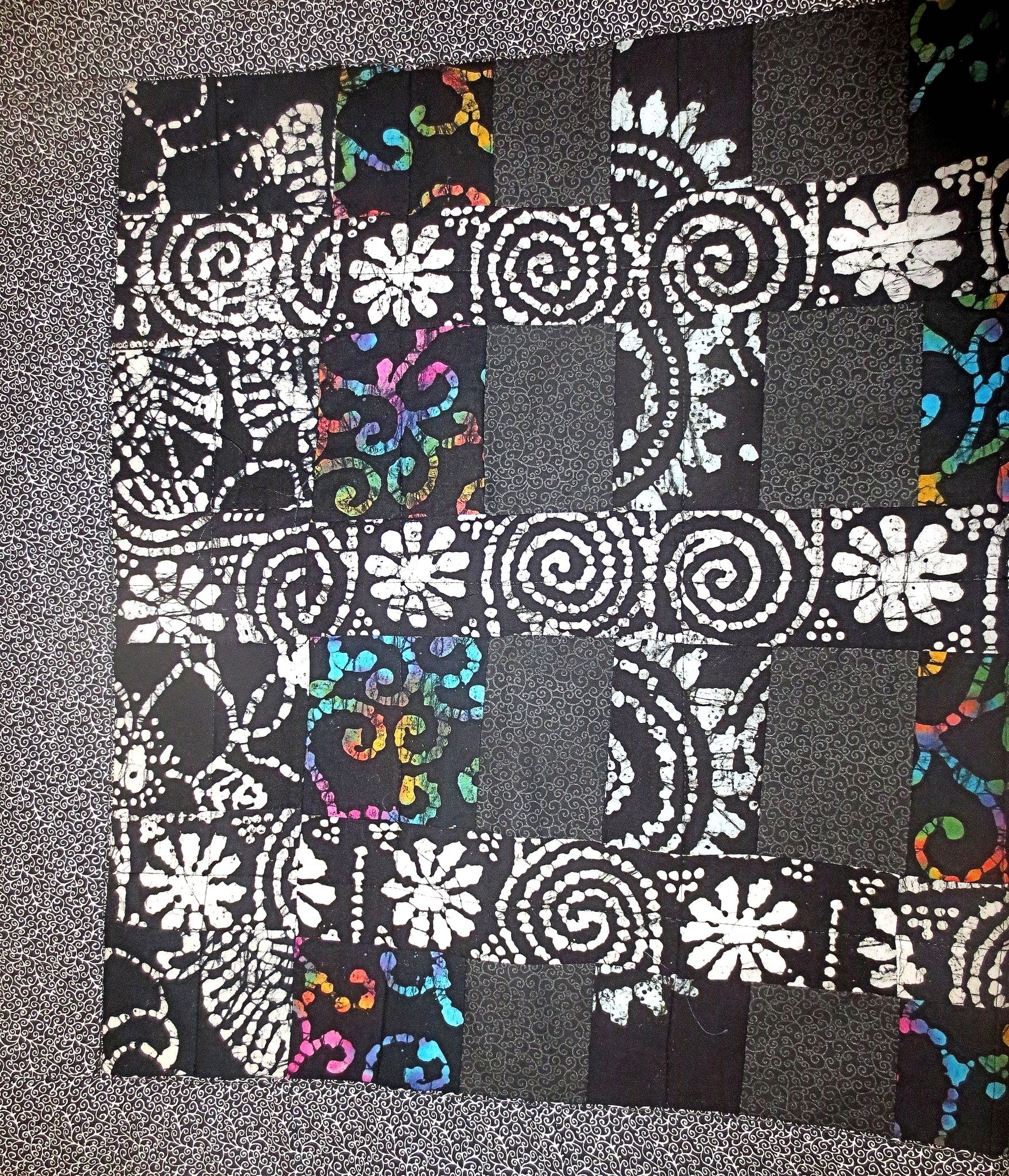 black batik and calico quilted insulated table runner with a splash of color