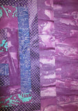 all purples batiks quilted insulated log cabin table runner with a splash of color