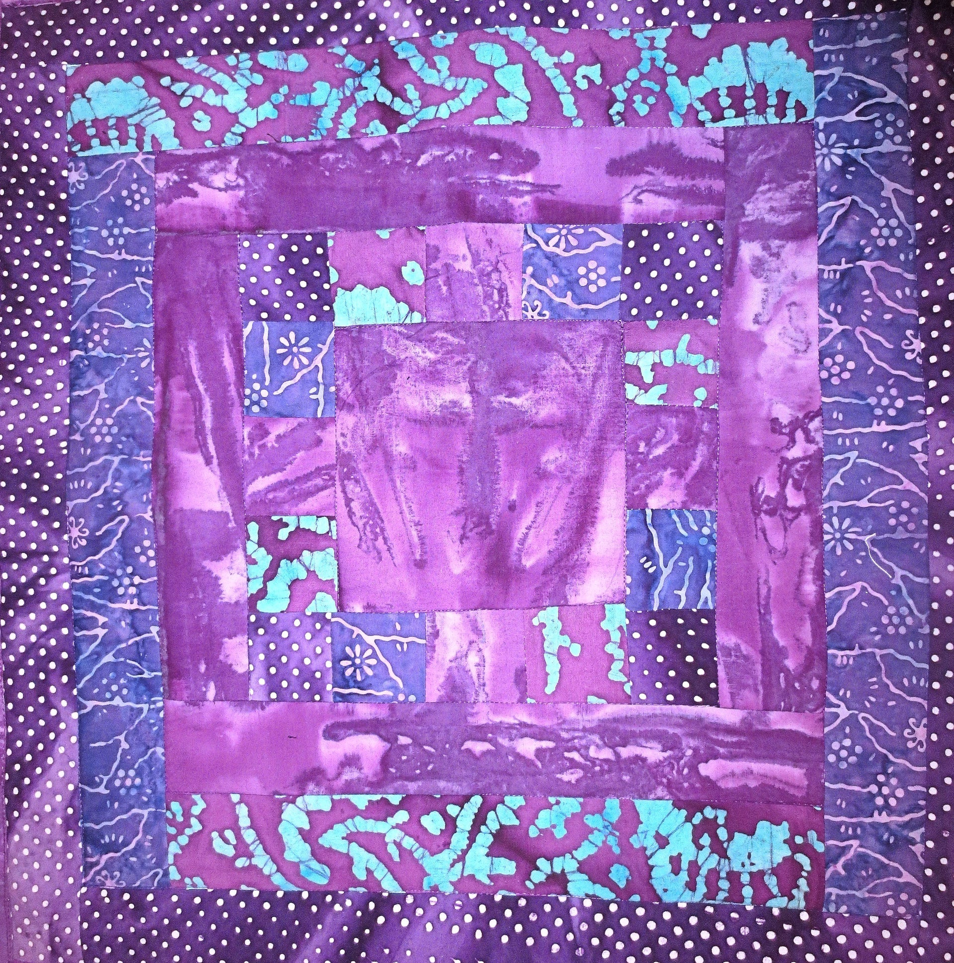 all purples batiks quilted insulated log cabin table runner with a splash of color