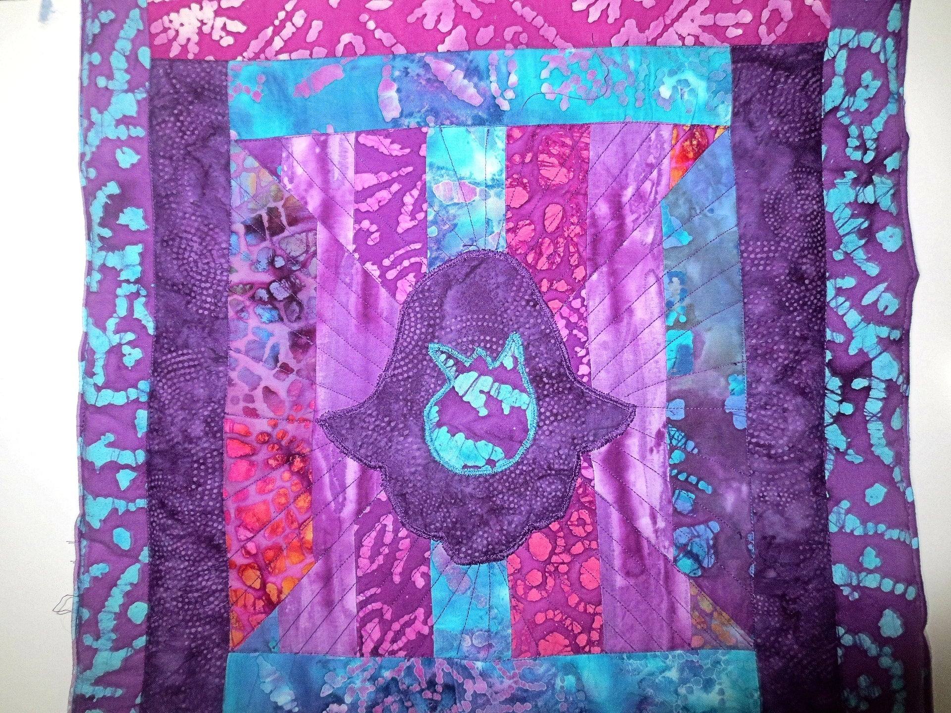 hamsa with pomegranate quilted batik wall hanging trapunto