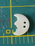Carved mother of pearl object and animals button