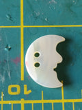 Carved mother of pearl object and animals button