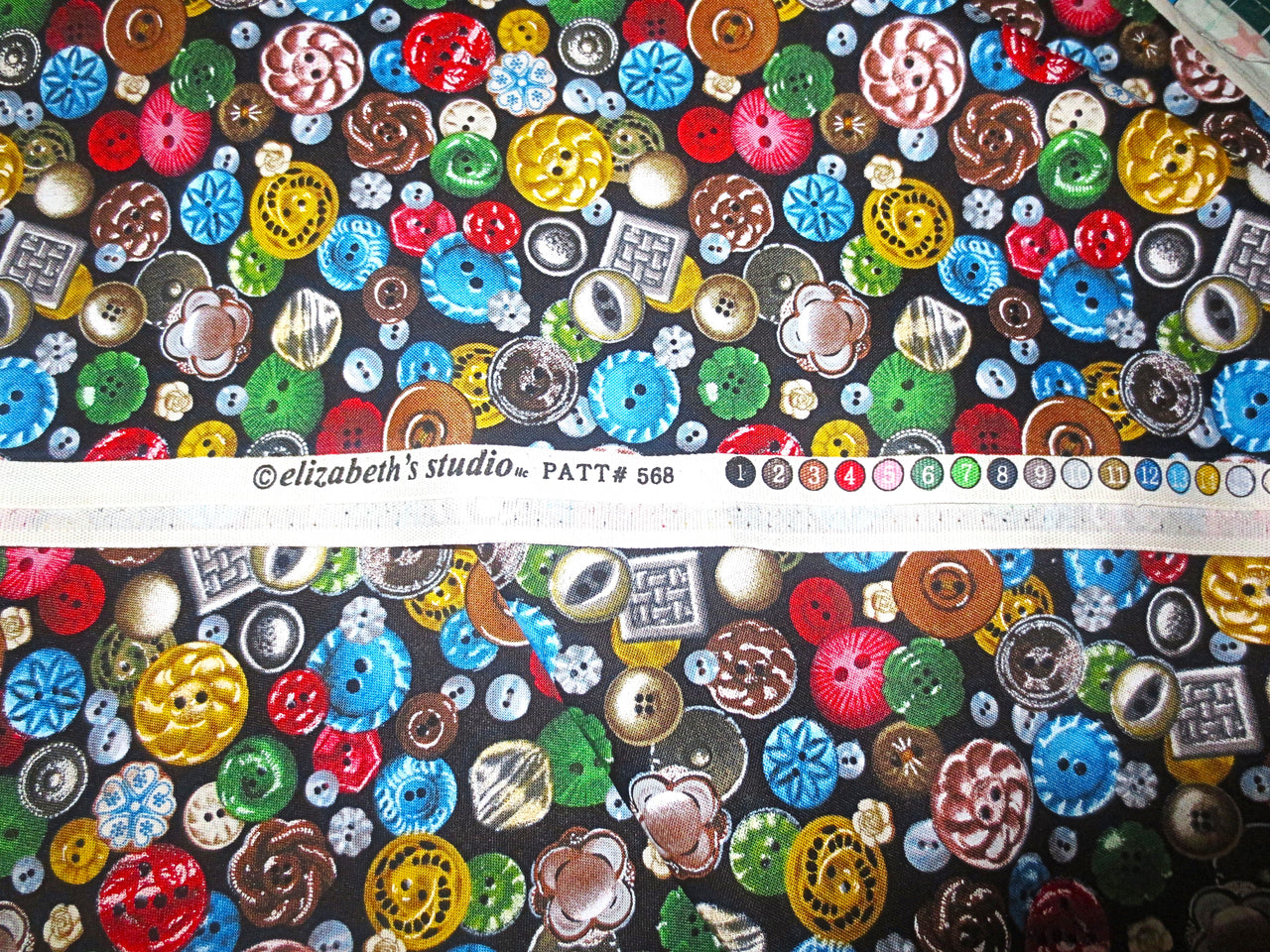 Colorful sewing Buttons tossed on black background Elizabeth Studios BhY oop