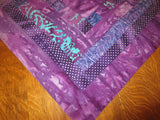 all purples batiks quilted insulated log cabin table runner with a splash of color