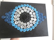 evil eye button art work with vintage buttons on canvas