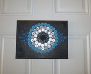 evil eye button art work with vintage buttons on canvas